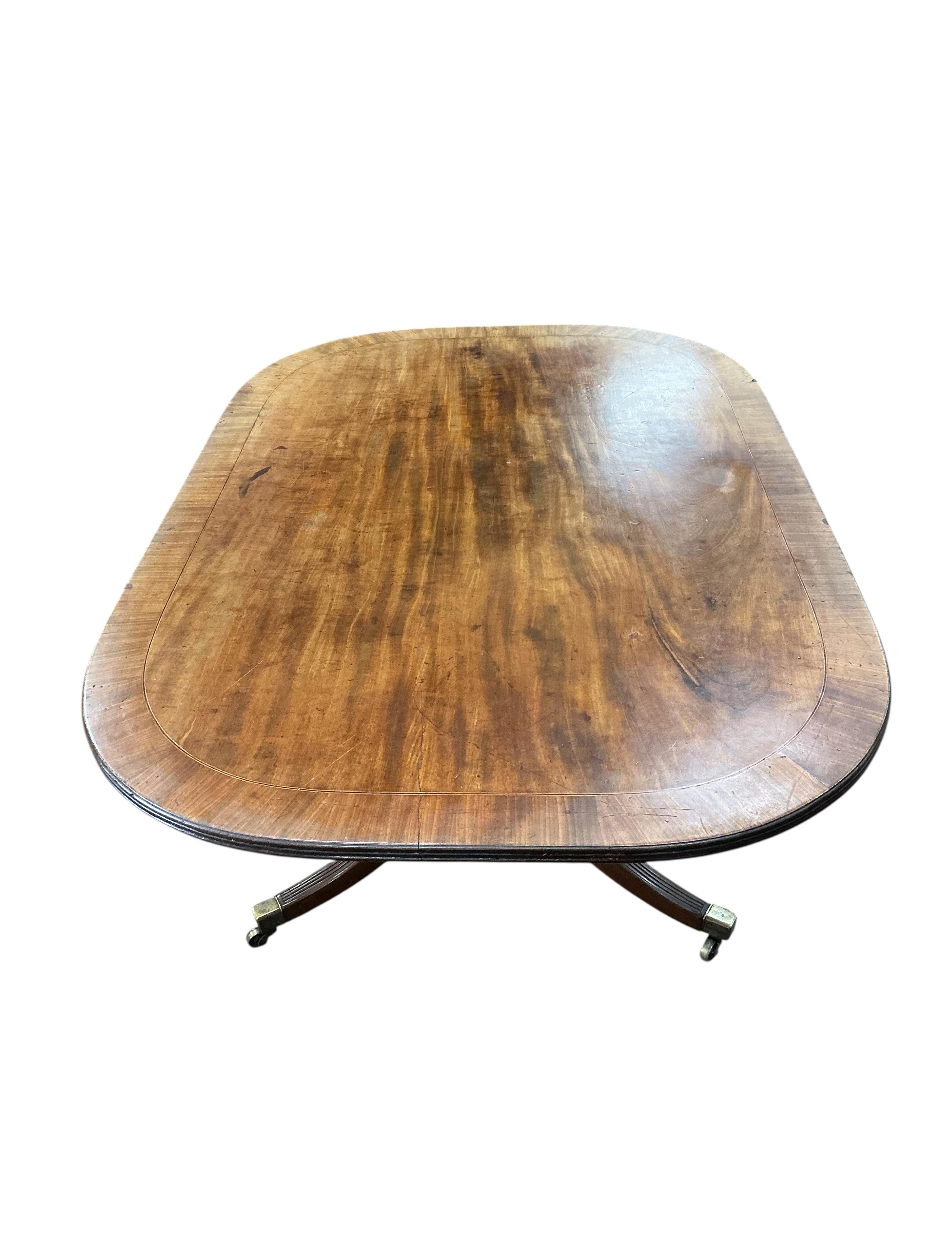 A George III mahogany rectangular tilt top dining table, width 126cm, depth 84cm, height 69cm